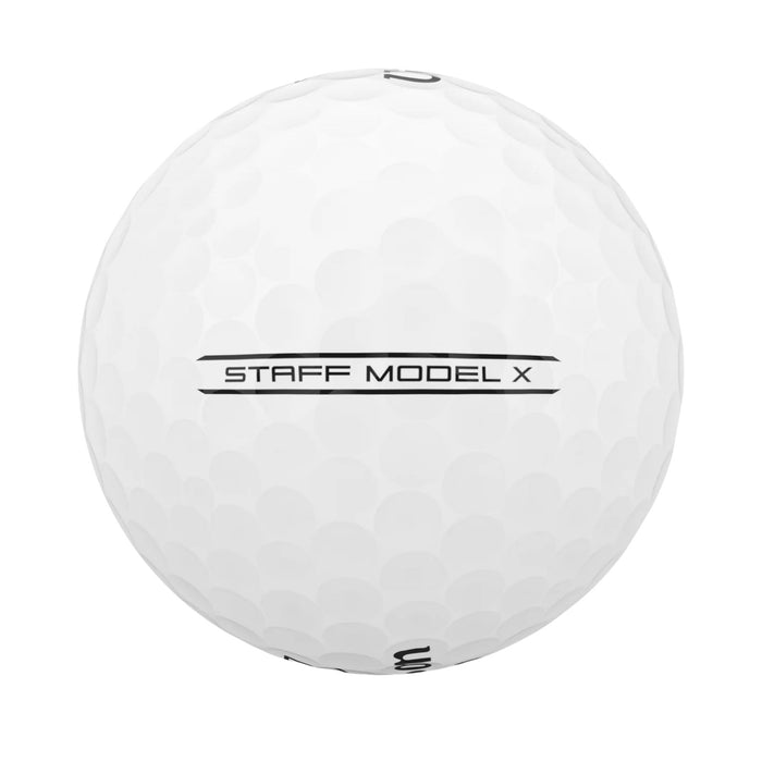 Side view of a white Wilson Staff Model X ball showing the STAFF MODEL X sidestamp between two lines
